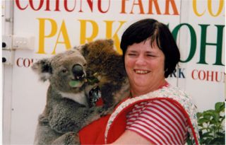 Ann holds a Koala bear in Australia